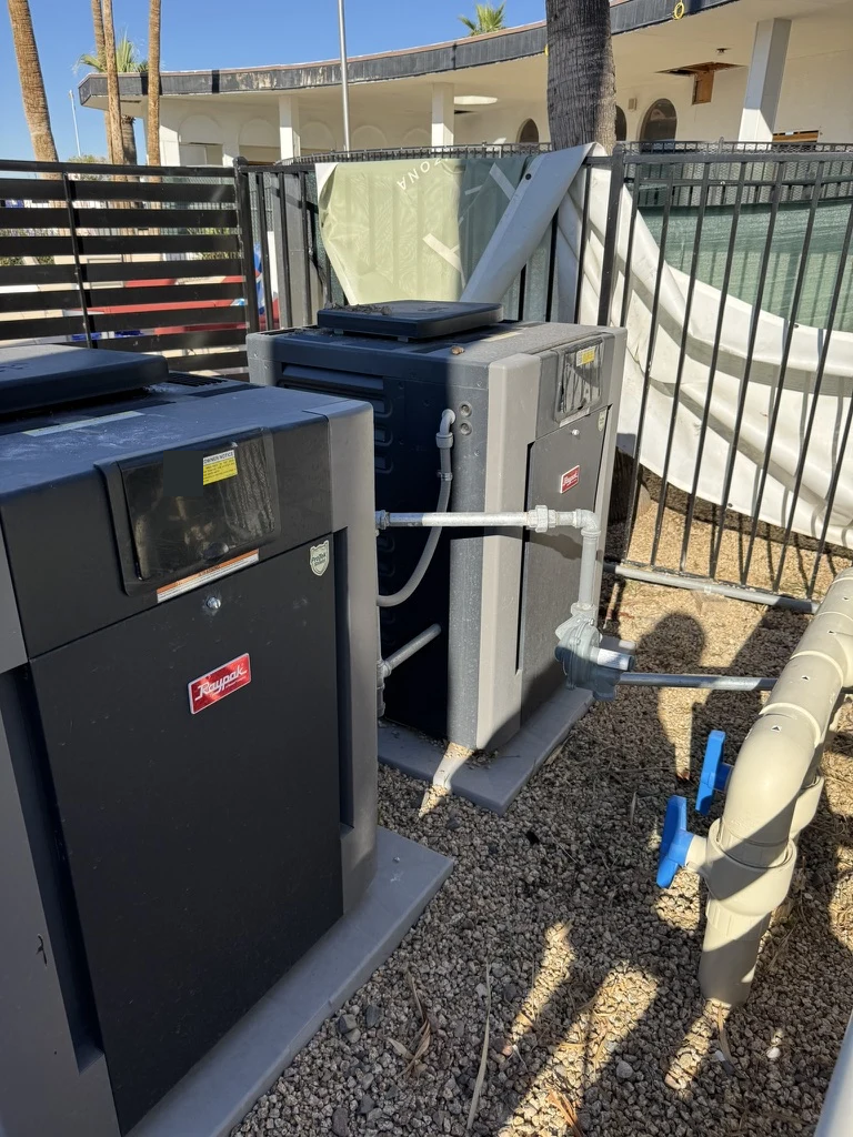 Twin gas-fired pool heaters with gas and water connections