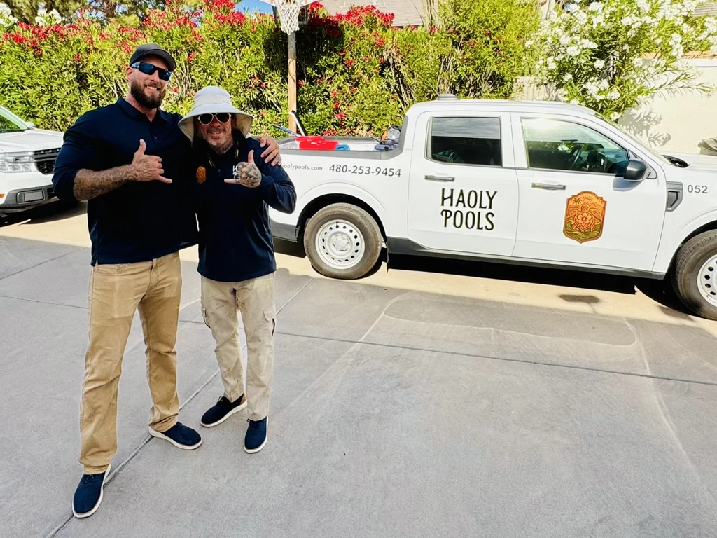 Robbie and Paule beside a Haoly Pools service truck