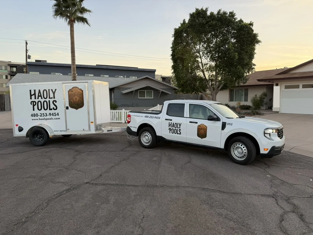 Haoly Pools truck and trailer from the front at sunset